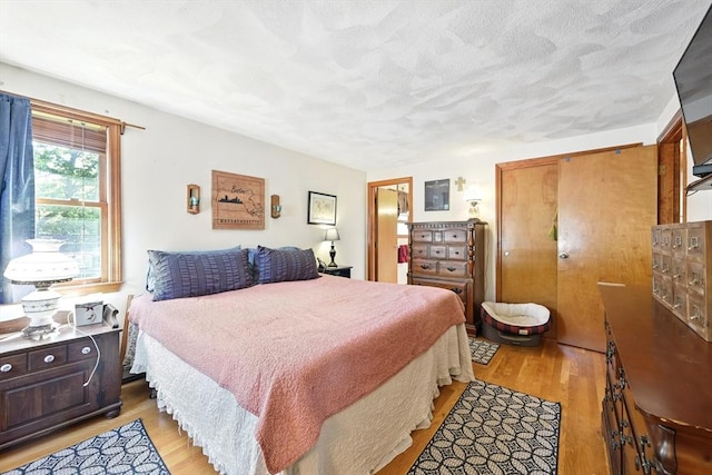81 Crosstown Ave, Boston, MA 02132 - bedroom featuring light wood-type flooring and a textured ceiling