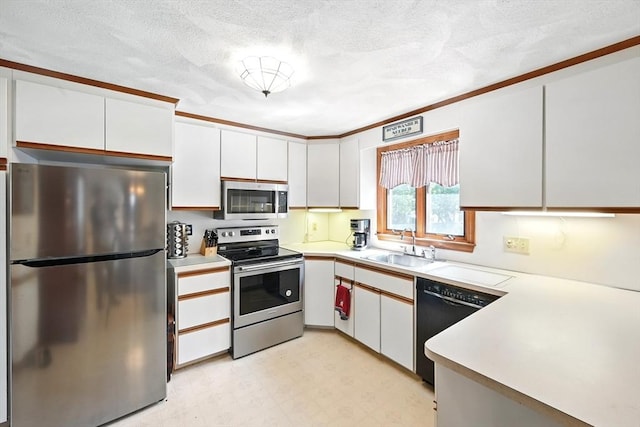 81 Crosstown Ave, Boston, MA 02132 - kitchen featuring appliances with stainless steel finishes, light countertops, light flooring, a sink, and a textured ceiling