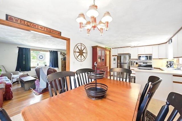 81 Crosstown Ave, Boston, MA 02132 - dining area featuring a chandelier and light wood-style flooring