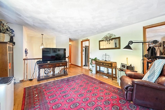 81 Crosstown Ave, Boston, MA 02132 - living area featuring wood finished floors, baseboards, and a textured ceiling