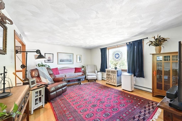 81 Crosstown Ave, Boston, MA 02132 - living area featuring baseboard heating, light wood-type flooring, and a textured ceiling