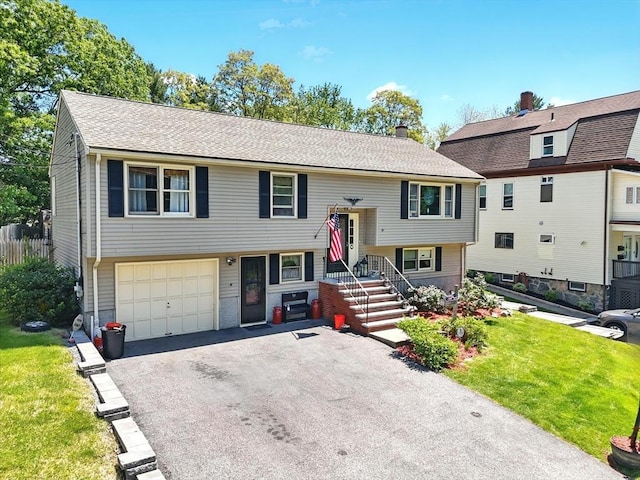 81 Crosstown Ave, Boston, MA 02132 - split foyer home featuring driveway, a front lawn, an attached garage, and a shingled roof