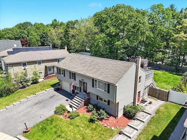81 Crosstown Ave, Boston, MA 02132 - view of front facade with driveway, a chimney, an attached garage, and a shingled roof