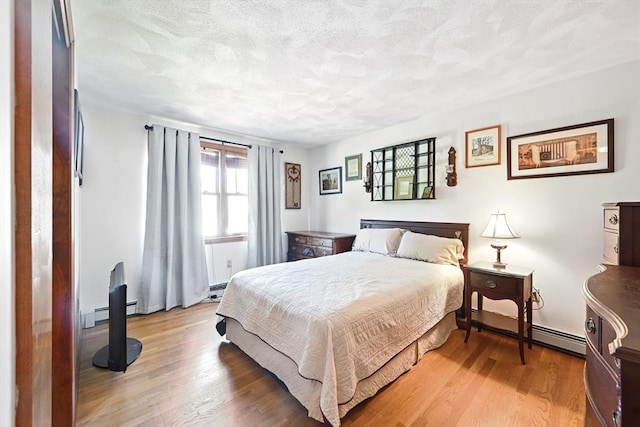 81 Crosstown Ave, Boston, MA 02132 - bedroom with light wood-type flooring, a textured ceiling, and a baseboard radiator