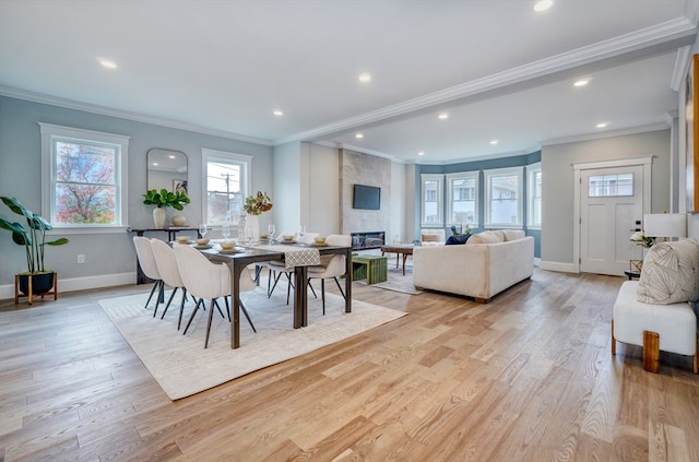 dining area with crown molding and light hardwood / wood-style flooring