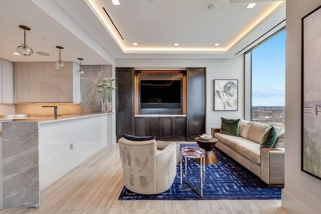 living room featuring a tray ceiling