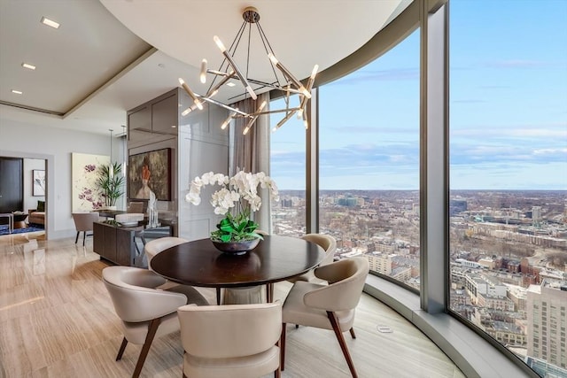 dining space featuring plenty of natural light, expansive windows, and a notable chandelier