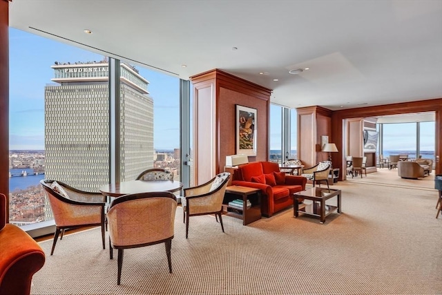 sitting room featuring light colored carpet and a water view