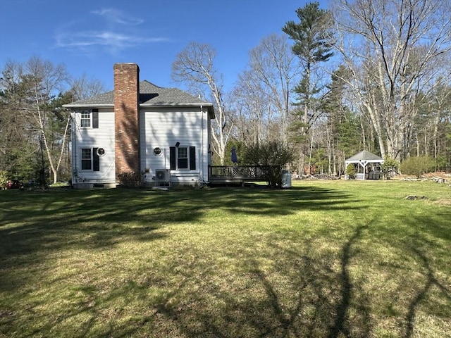 view of grassy yard with a gazebo and a deck