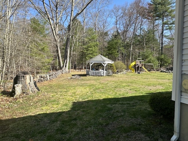 view of grassy yard with a gazebo and a playground