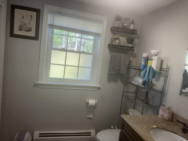 bathroom with a baseboard heating unit, toilet, and vanity