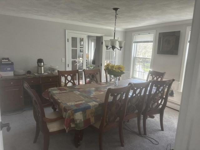 dining room with crown molding, light colored carpet, a chandelier, and a textured ceiling