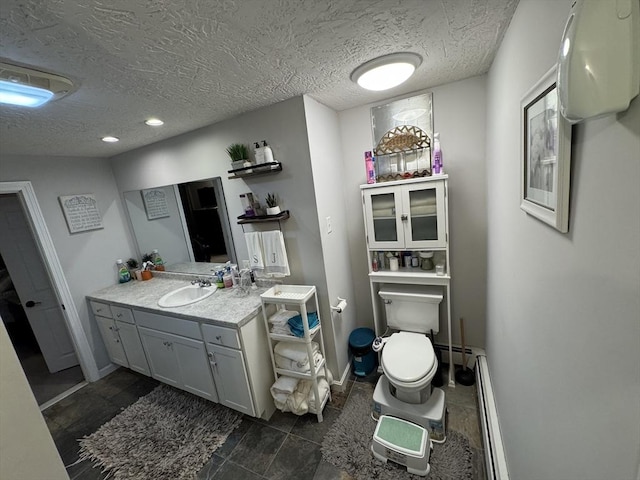 bathroom with a textured ceiling, baseboard heating, vanity, toilet, and baseboards