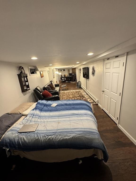bedroom with dark wood finished floors, recessed lighting, baseboard heating, and baseboards