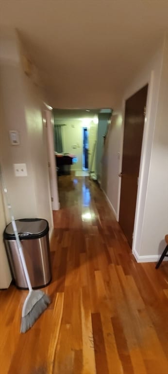 corridor with hardwood / wood-style floors