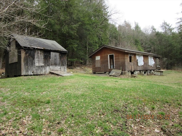 86 Ashfield Rd, Williamsburg, MA 01096 - view of yard featuring an outdoor structure, a view of trees, and a storage shed