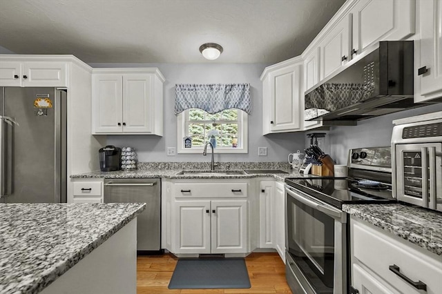 3 Spindletop Dr, Leominster, MA 01453 - kitchen featuring stainless steel appliances, white cabinets, light wood-style flooring, and light stone countertops