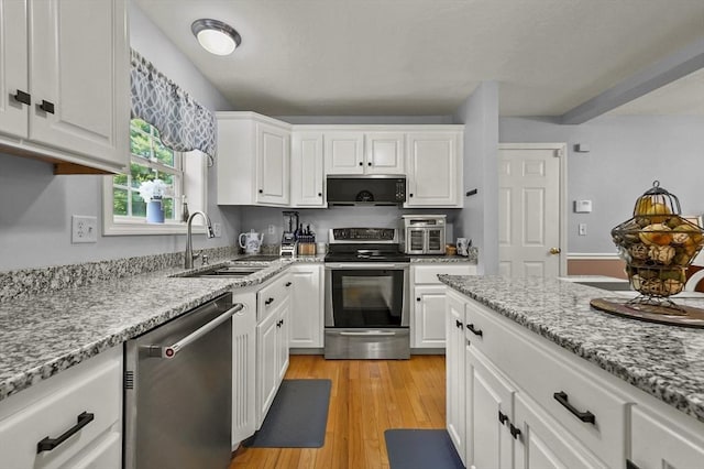 3 Spindletop Dr, Leominster, MA 01453 - kitchen with appliances with stainless steel finishes, white cabinets, light wood-style floors, and light stone counters