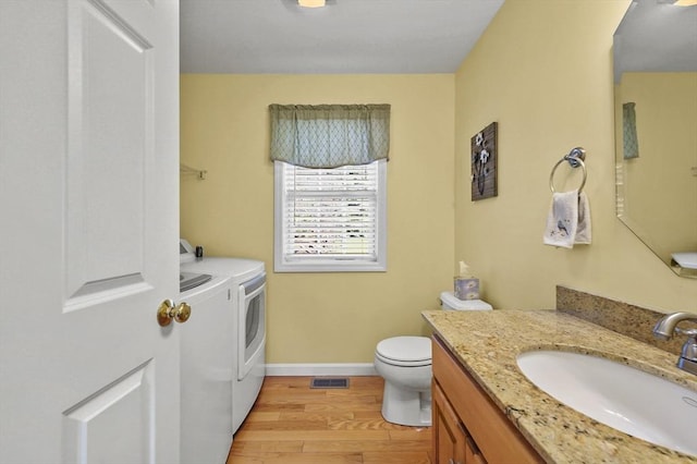 3 Spindletop Dr, Leominster, MA 01453 - bathroom featuring independent washer and dryer, wood finished floors, and vanity