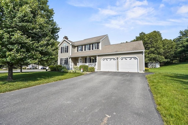 3 Spindletop Dr, Leominster, MA 01453 - colonial home with covered porch, an attached garage, a front lawn, driveway, and a chimney
