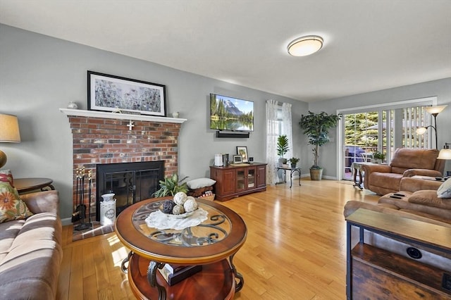 3 Spindletop Dr, Leominster, MA 01453 - living area featuring light wood finished floors and a brick fireplace