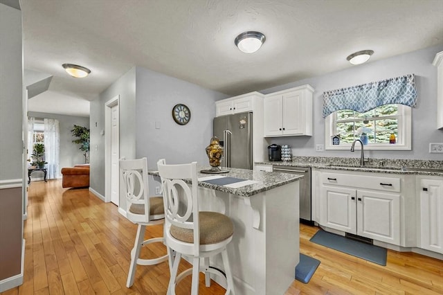 3 Spindletop Dr, Leominster, MA 01453 - kitchen with stainless steel appliances, light stone countertops, plenty of natural light, white cabinets, and a textured ceiling