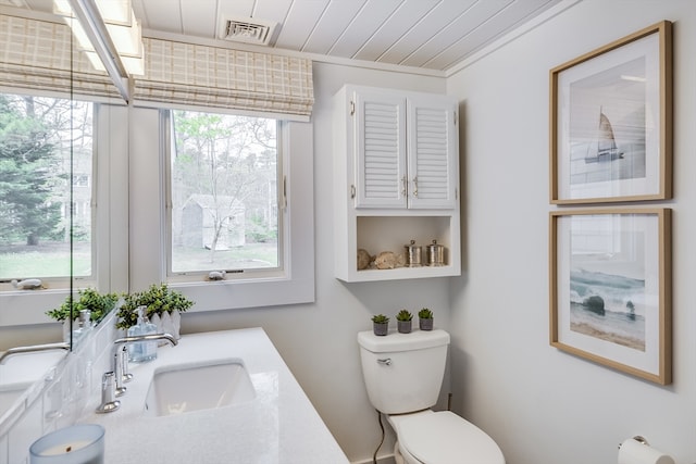 half bathroom with a sink, toilet, and wood ceiling