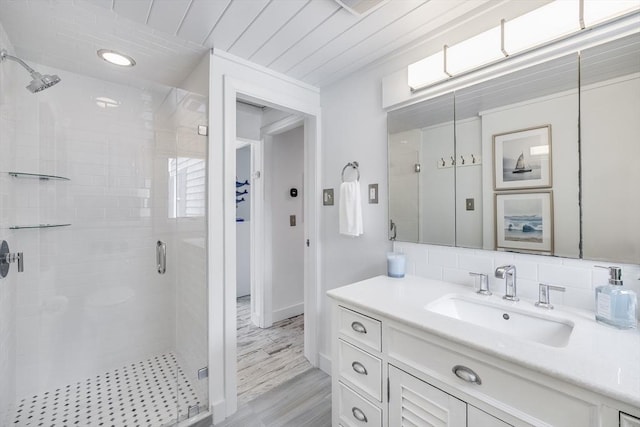 full bath featuring a shower stall, wood finished floors, vanity, and wood ceiling