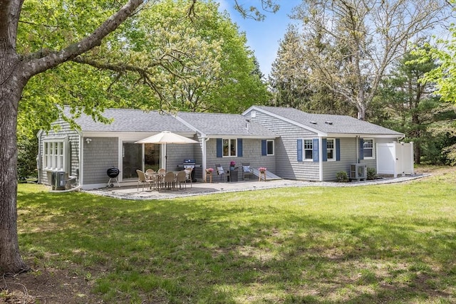 back of house featuring a lawn, a patio area, central AC, and roof with shingles
