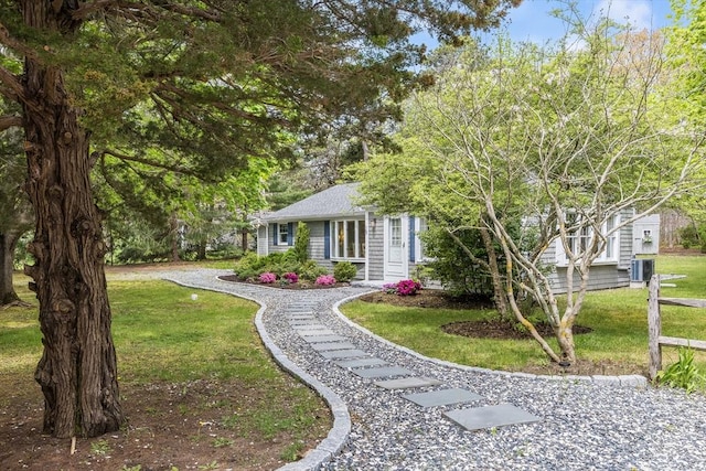 ranch-style home with central AC and a front lawn