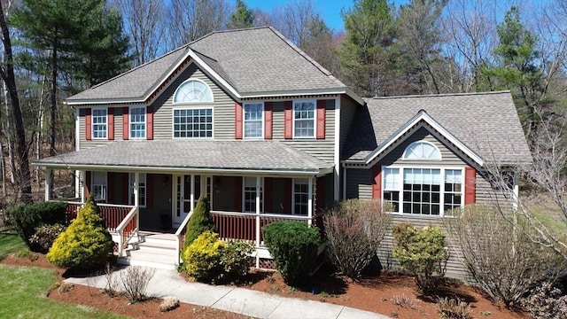 view of front of property featuring a shingled roof and covered porch