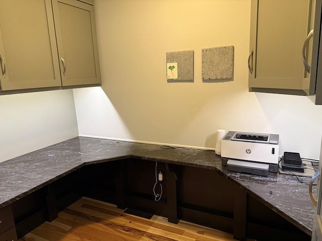 unfurnished office with wood finished floors