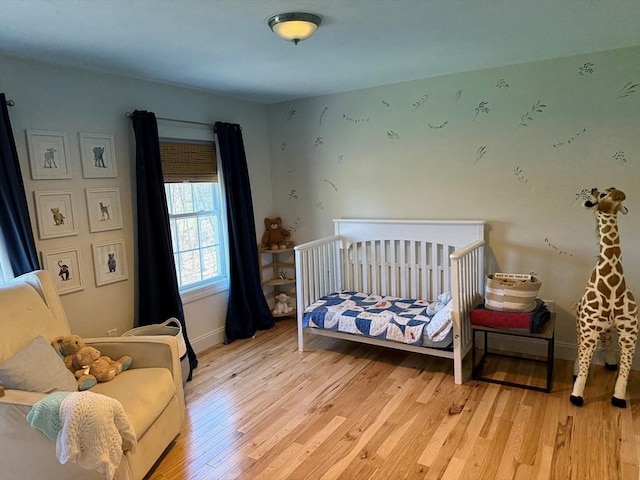 bedroom with wood finished floors and baseboards
