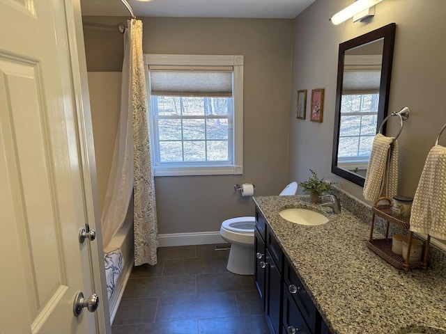 bathroom with a wealth of natural light, tile patterned floors, vanity, and toilet