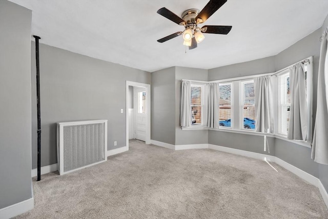 empty room with light colored carpet and ceiling fan