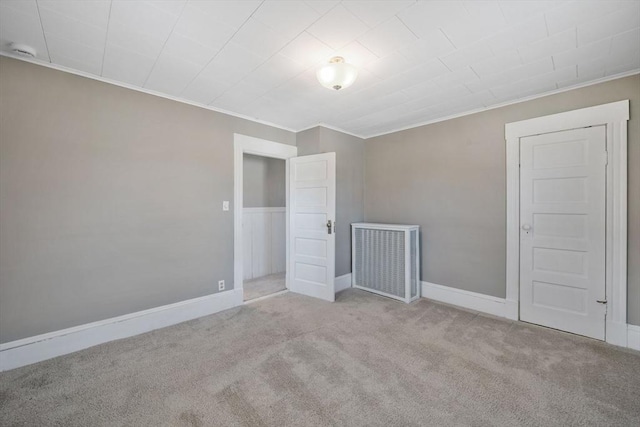 carpeted empty room with ornamental molding