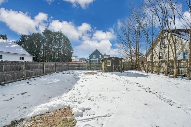 yard covered in snow featuring a storage unit