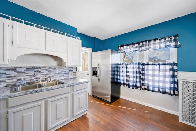 kitchen with white cabinetry, dark hardwood / wood-style floors, sink, and stainless steel fridge with ice dispenser