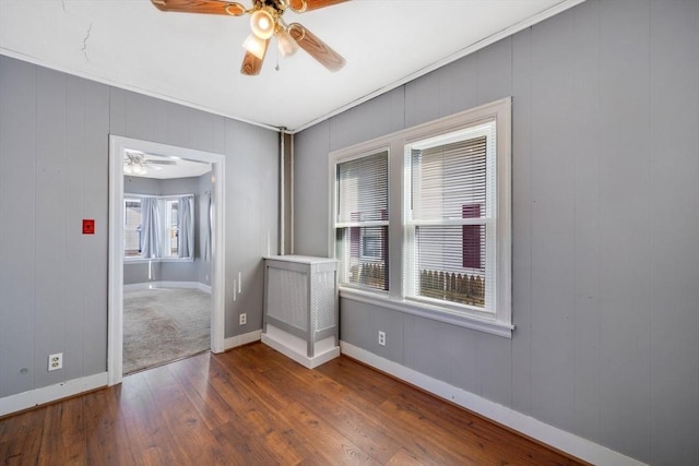 empty room featuring dark hardwood / wood-style flooring and ceiling fan