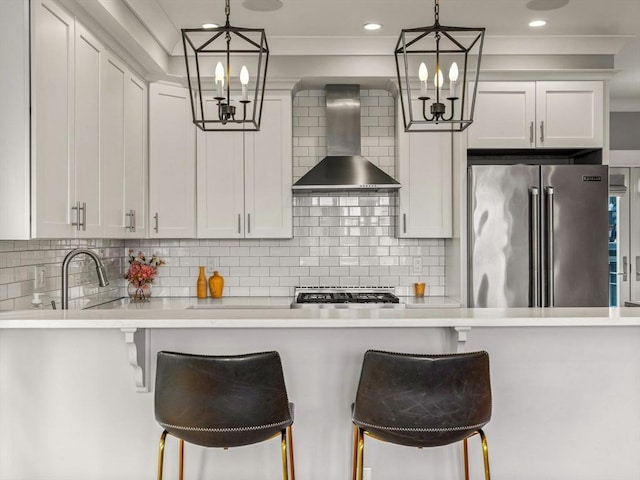 49 Coffey St Unit B, Boston, MA 02122 - kitchen featuring wall chimney exhaust hood, high quality fridge, a chandelier, a breakfast bar, and recessed lighting