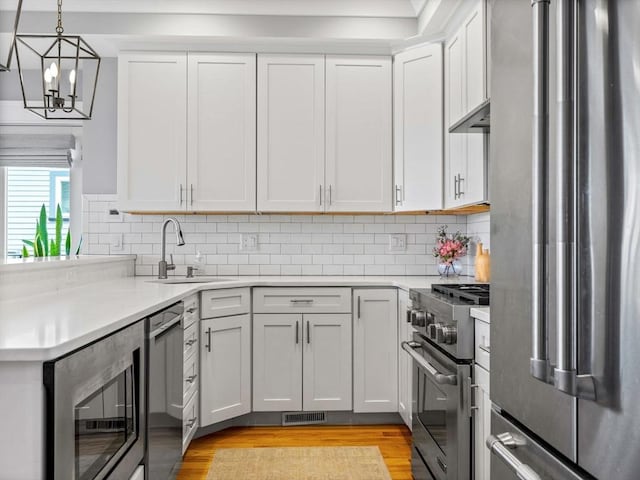 49 Coffey St Unit B, Boston, MA 02122 - kitchen featuring stainless steel appliances, a sink, light wood-style floors, and light countertops