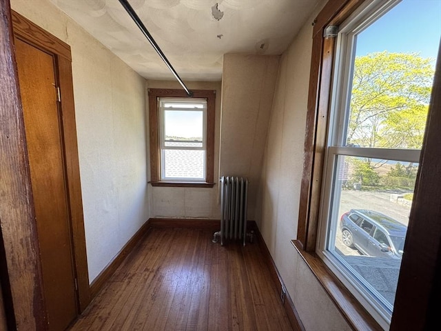 interior space featuring baseboards, dark wood finished floors, and radiator