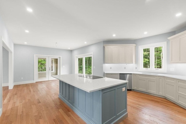 kitchen featuring black electric stovetop, french doors, light hardwood / wood-style flooring, dishwasher, and a center island