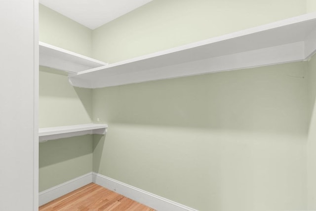 walk in closet featuring hardwood / wood-style floors