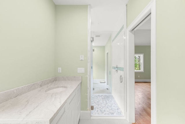 bathroom featuring tile patterned floors, vanity, and an enclosed shower