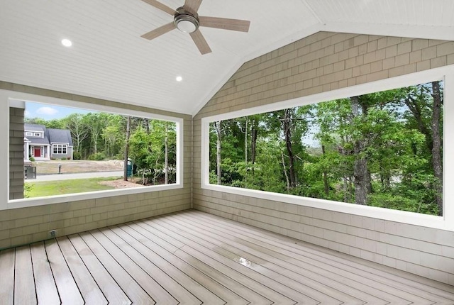 unfurnished sunroom with vaulted ceiling and ceiling fan