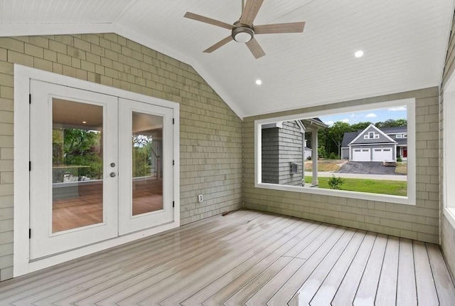 unfurnished sunroom featuring ceiling fan, lofted ceiling, and french doors