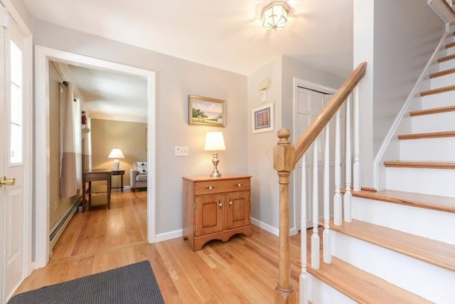 entrance foyer with light hardwood / wood-style floors and baseboard heating