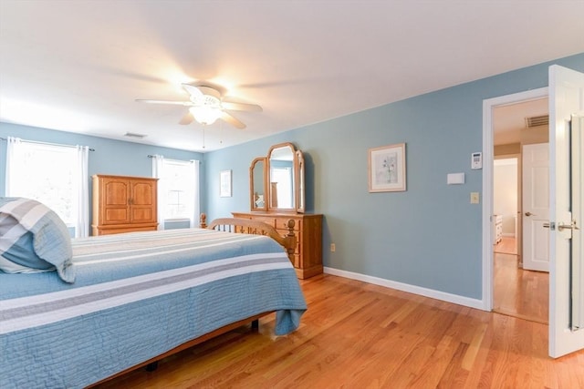 bedroom with ceiling fan and light hardwood / wood-style floors