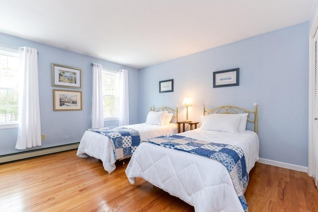 bedroom featuring hardwood / wood-style flooring and a baseboard radiator